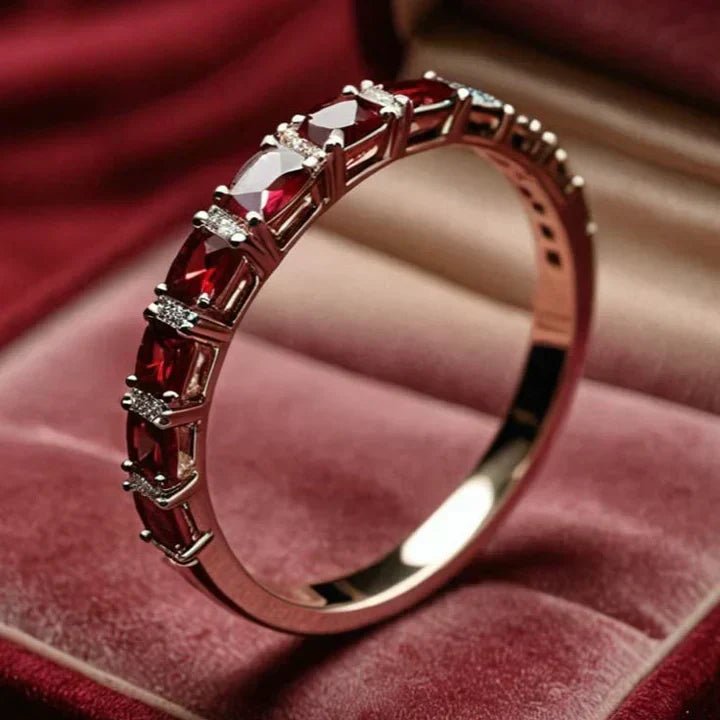 Gold ring adorned with red crystal embellishments