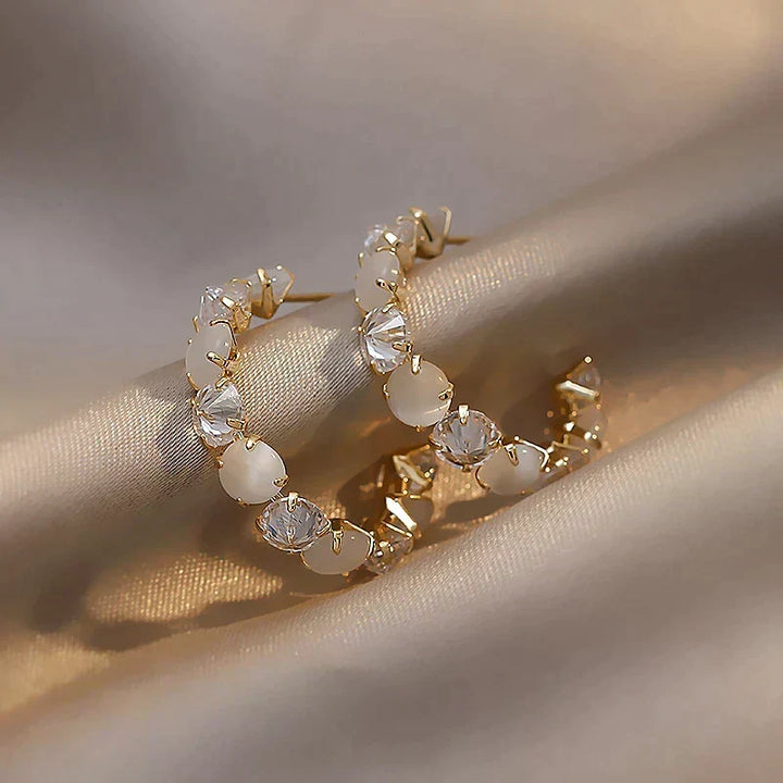 Chic Gold Earrings Adorned with White Opal and Crystal Details