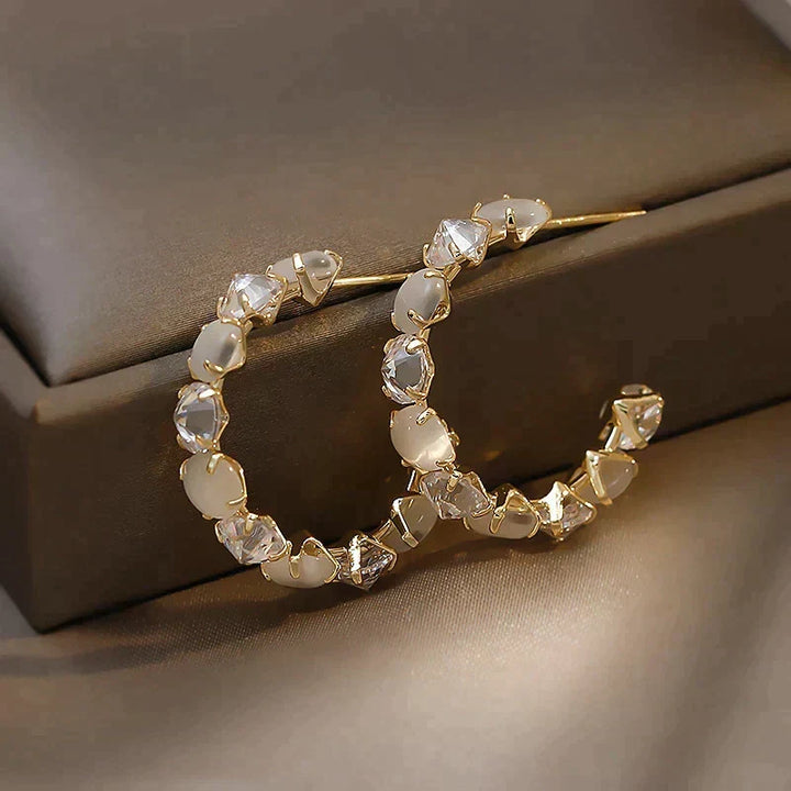 Sophisticated Gold Earrings Featuring White Opal and Crystal Details