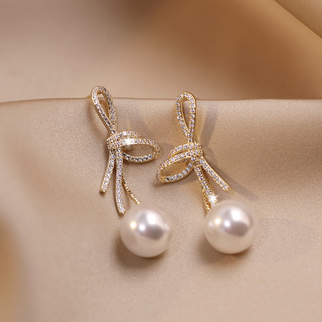 Gold Bow-Accent Pearl Earrings with a Dazzling Finish